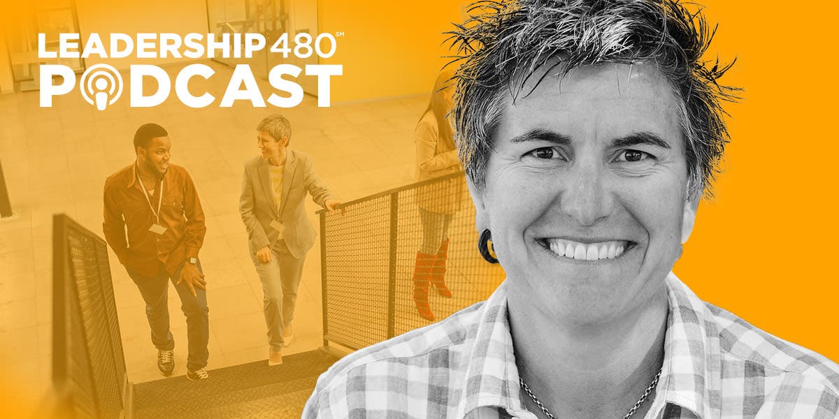 headshot of Ash Beckham with an image of two leaders in the background happily walking up stairs together to show this podcast episode gives tips for how to step up as an inclusive leader so everyone can bring their full selves to the job