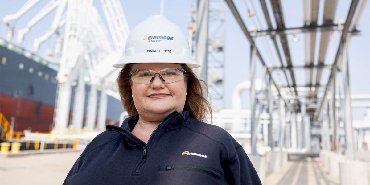 Enbridge energy supervisor working in the field, smiling confidently to show this client story is about how Enbridge turned its supervisors into great coaches using leadership development content from DDI