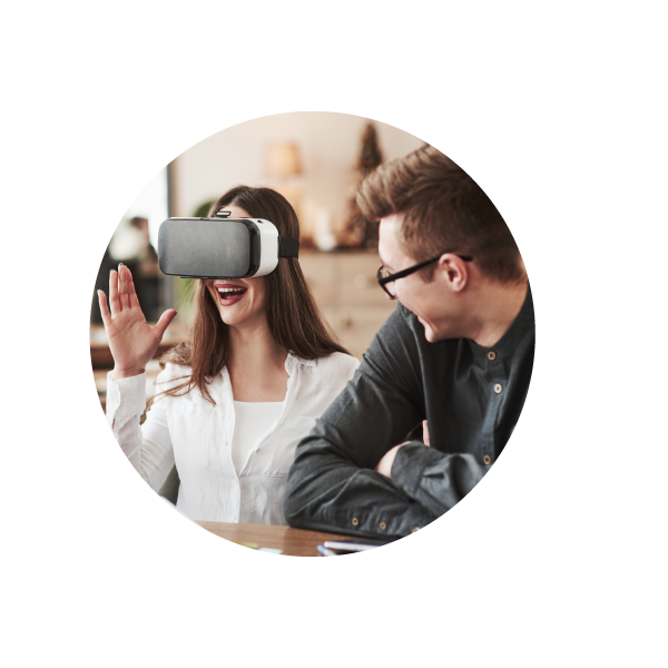 female business professional with a VR headset on sitting beside a male VR experience facilitator ?auto=format&q=75