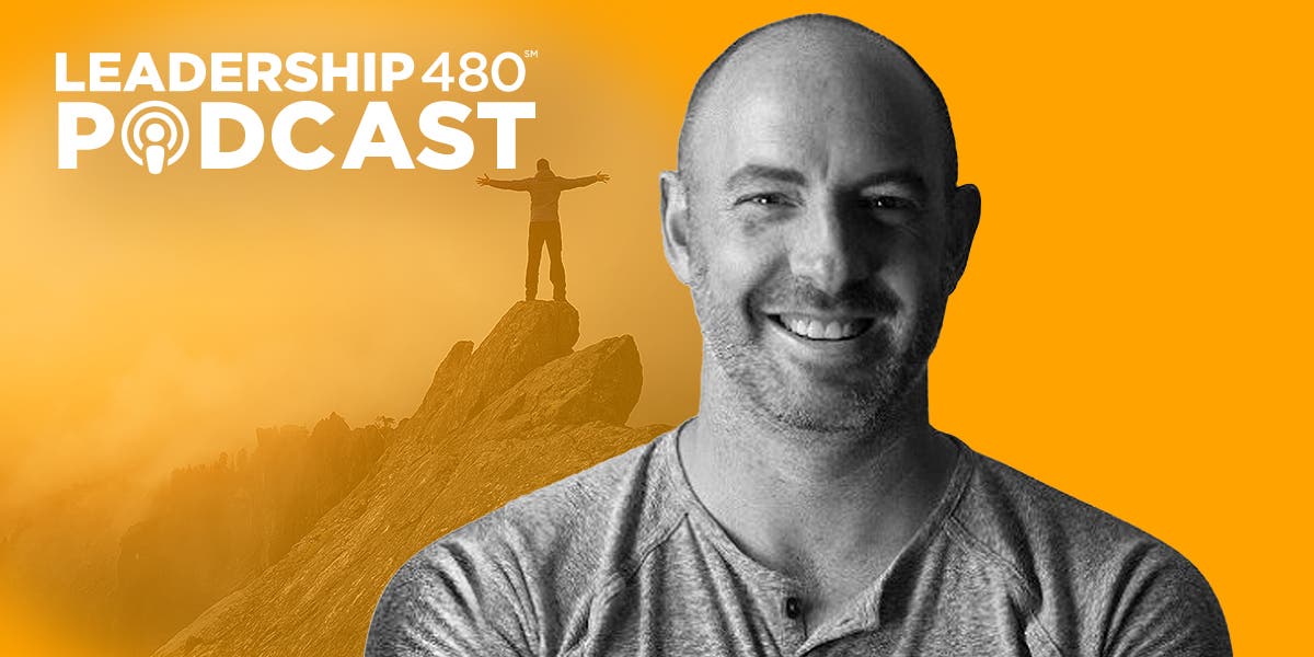 headshot of author Ryan Berman with image of man standing on mountain in the background to represent discussion of courage in leadership on the Leadership 480 podcast