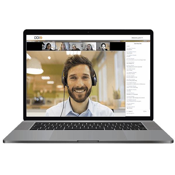 Picture of man on computer screen engaging in lively conversation with a group of diverse peers as part of a virtual classroom