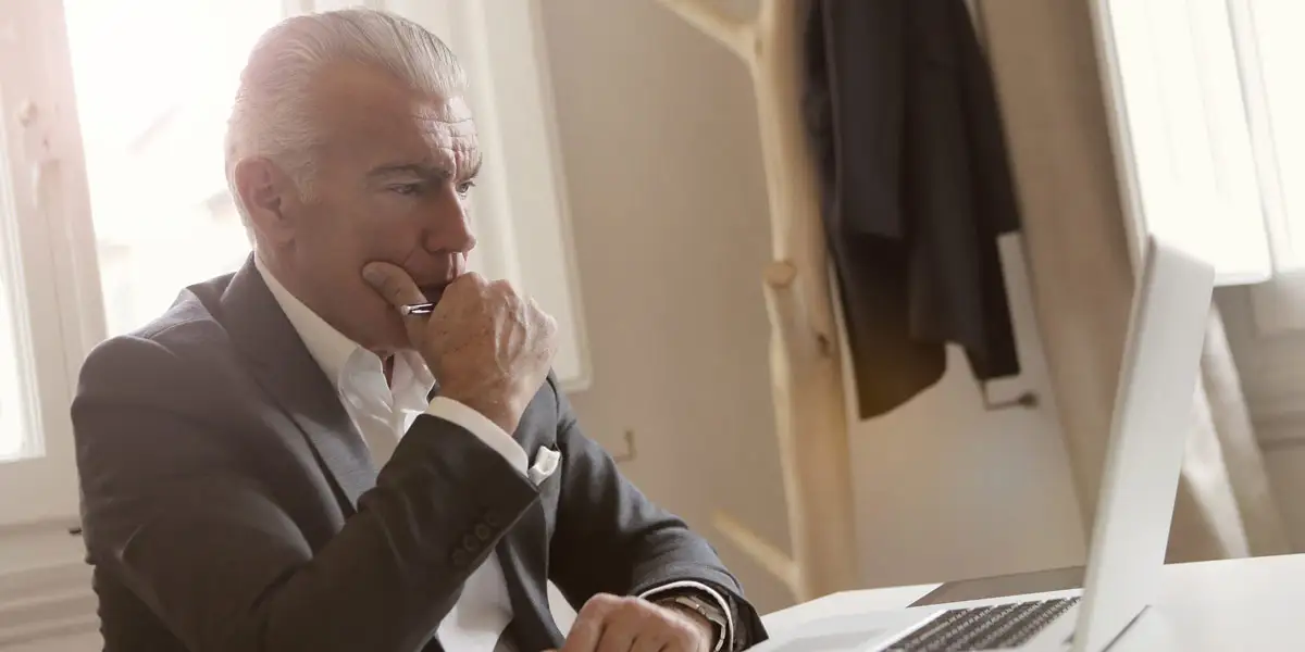 male executive looking at laptop