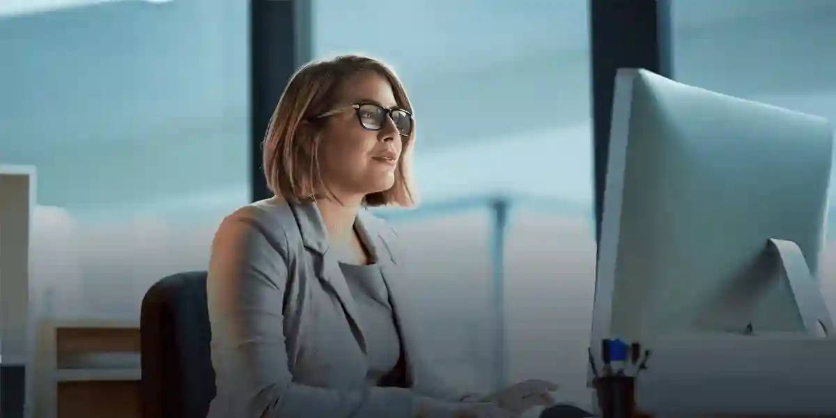 content, confident woman executive working on a computer in an office building