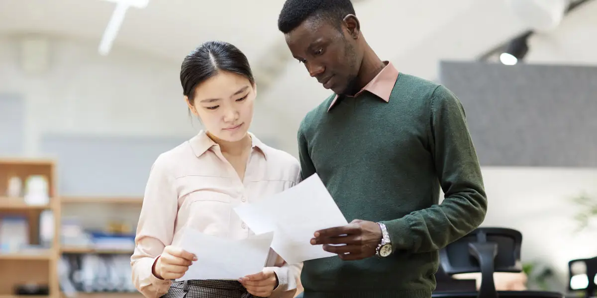 man and woman looking at papers