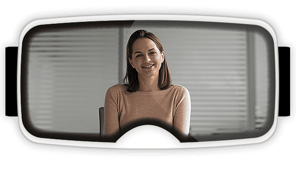 View inside of a virtual reality headset with a women sitting at a desk speaking to you as part of a virtual reality for soft skills training program?auto=format&q=75