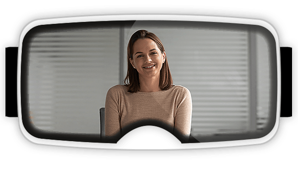 View inside of a virtual reality headset with a women sitting at a desk speaking to you as part of a virtual reality for soft skills training program?fm=webp&q=15