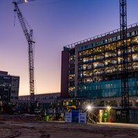 Sunset view of the building with lights on