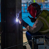 Person welding metal.