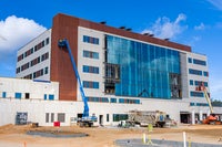 View of front of new Bear Family foundation Health Center building with crane in front.