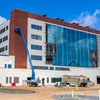 View of front of new Bear Family foundation Health Center building with crane in front.