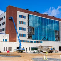 View of front of new Bear Family foundation Health Center building with crane in front.