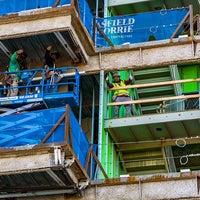 Workers on a lift giving the camera a thumbs up