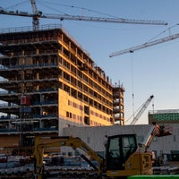 A shot of the building with two cranes