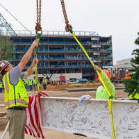 Workers attaching a flag to the beam