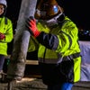 Workers lifting a pipe