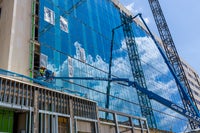 View of glass exterior with crane reflectionl.