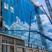 View of glass exterior with crane reflectionl.
