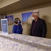 Team members pose in behind beam signing event.
