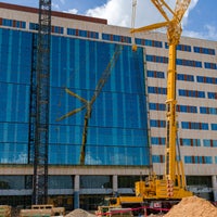 View of front of new Baptist Hospital with crane in front. 