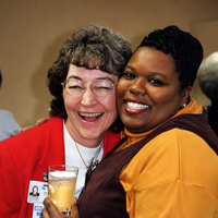 Working at a great place and creating lasting friendships two women smiling at camera
