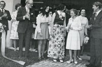 Mrs. Earl Gaston cuts ribbon opening for enlarged hospital.