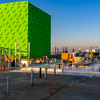 A big green box on the roof of the building