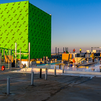 A big green box on the roof of the building