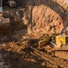 Construction digger vehicles digging dirt.