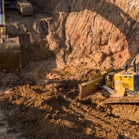 Construction digger vehicles digging dirt.