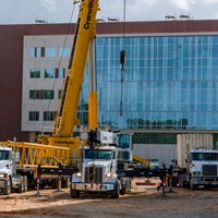 Front view of new hospital with crane in front.