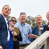 Mark Faulkner and a group looking up at the building