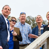 Mark Faulkner and a group looking up at the building