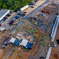 Overhead view of construction crew gathering together.