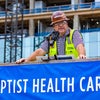 Construction team leader speaking at topping off beam celebration.