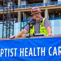 Construction team leader speaking at topping off beam celebration.