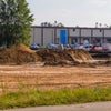 View of leveled ground with building beyond area.