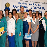Group in front of voted number 1 patient satisfaction sign