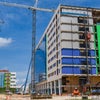 Construction of exterior of new campus with crane.