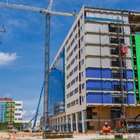 Construction of exterior of new campus with crane.