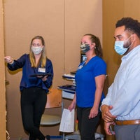 Staff observing mock up area.