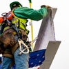 Worker steadying the beam