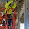Worker screwing in metal