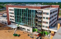 Overview of Bear Family Foundation Health Center with crane installing window.