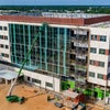 Overview of Bear Family Foundation Health Center with crane installing window.