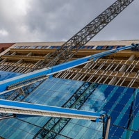 Front of new Baptist Hospital with cranes installing windows.