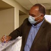 A man signing the beam