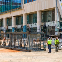 Crew with crane ready to pull up metal piece.