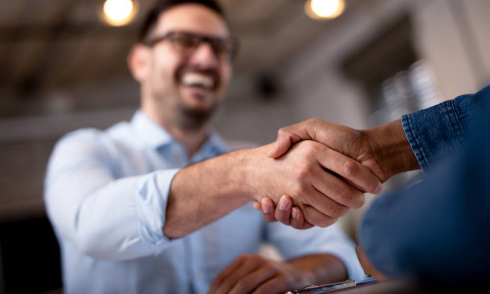 Two men shake hands during a metting.jpeg