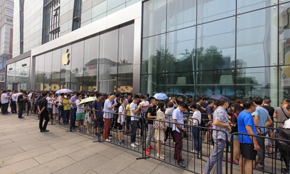 eople queue outside an Apple Store.jpg