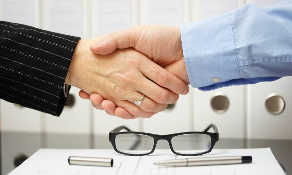 Businessman and client are handshaking over agreement (1).jpg
